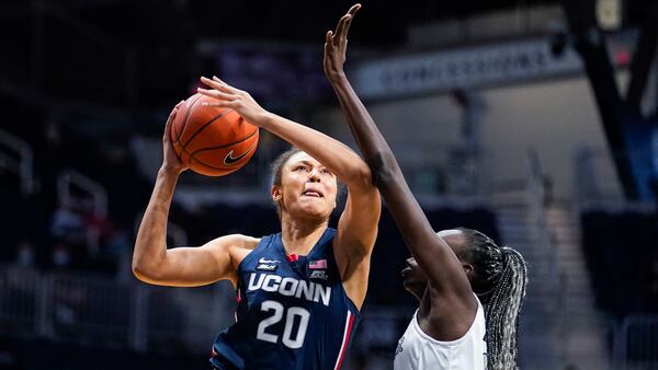 Connecticut forward Olivia Nelson-Ododa (20) shoots over Butler forward Nyamer Diew (13) during the first quarter Saturday, Feb. 27, 2021, in Indianapolis. (Michael Conroy/AP)