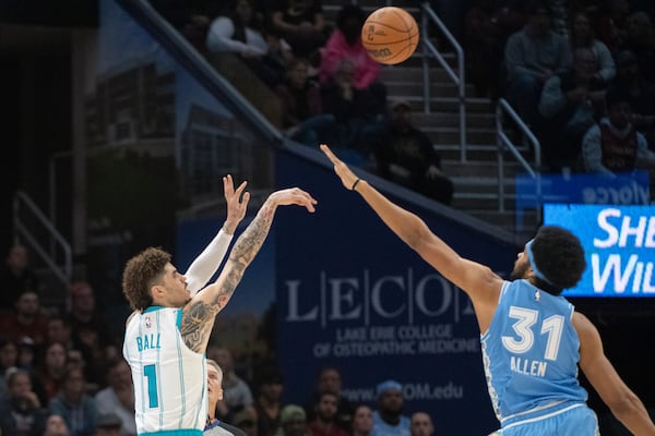 Charlotte Hornets' LaMelo Ball (1) shoots over Cleveland Cavaliers' Jarrett Allen (31) during the first half of an NBA basketball game in Cleveland, Sunday, Nov 17, 2024. (AP Photo/Phil Long)