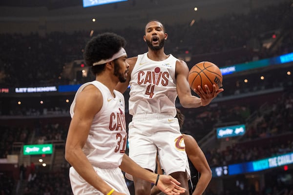 Cleveland Cavaliers' Evan Mobley (4) grabs a rebound as Jarrett Allen (31) stands by during the first half of an NBA basketball game against the Brooklyn Nets in Cleveland, Saturday, Nov. 9, 2024. (AP Photo/Phil Long)