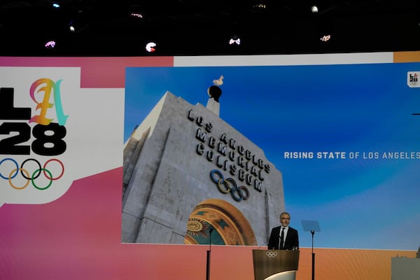 Casey Wasserman, chairman of the 2028 Los Angeles Olympics organizing committee, speaks during the 144th International Olympic Committee session, which will elect the new IOC President, in Costa Navarino, western Greece, Thursday, March 20, 2025. (AP Photo/Thanassis Stavrakis)