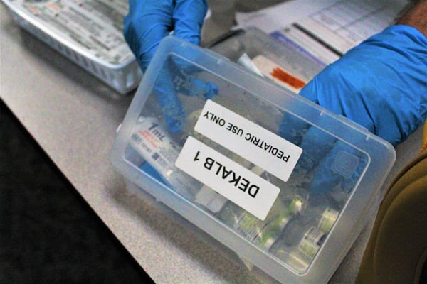 Tony Paccasassi prepares COVID-19 vaccines at the Latin American Association's vaccination day on Sept. 17, 2022.