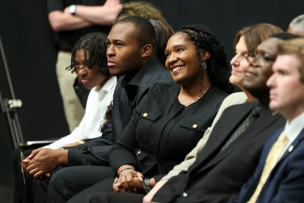 Starlett Mack, center, reacts as her husband Jerry Mack speaks during his introductory event as the Kennesaw State head coach at the KSU Convocation Center, Tuesday, December 3, 2024, in Kennesaw, Ga. Mack replaces Kennesaw State coach Brian Bohannon, who was has been the program’s only coach since its inception in 2015. Jason Getz / AJC)
