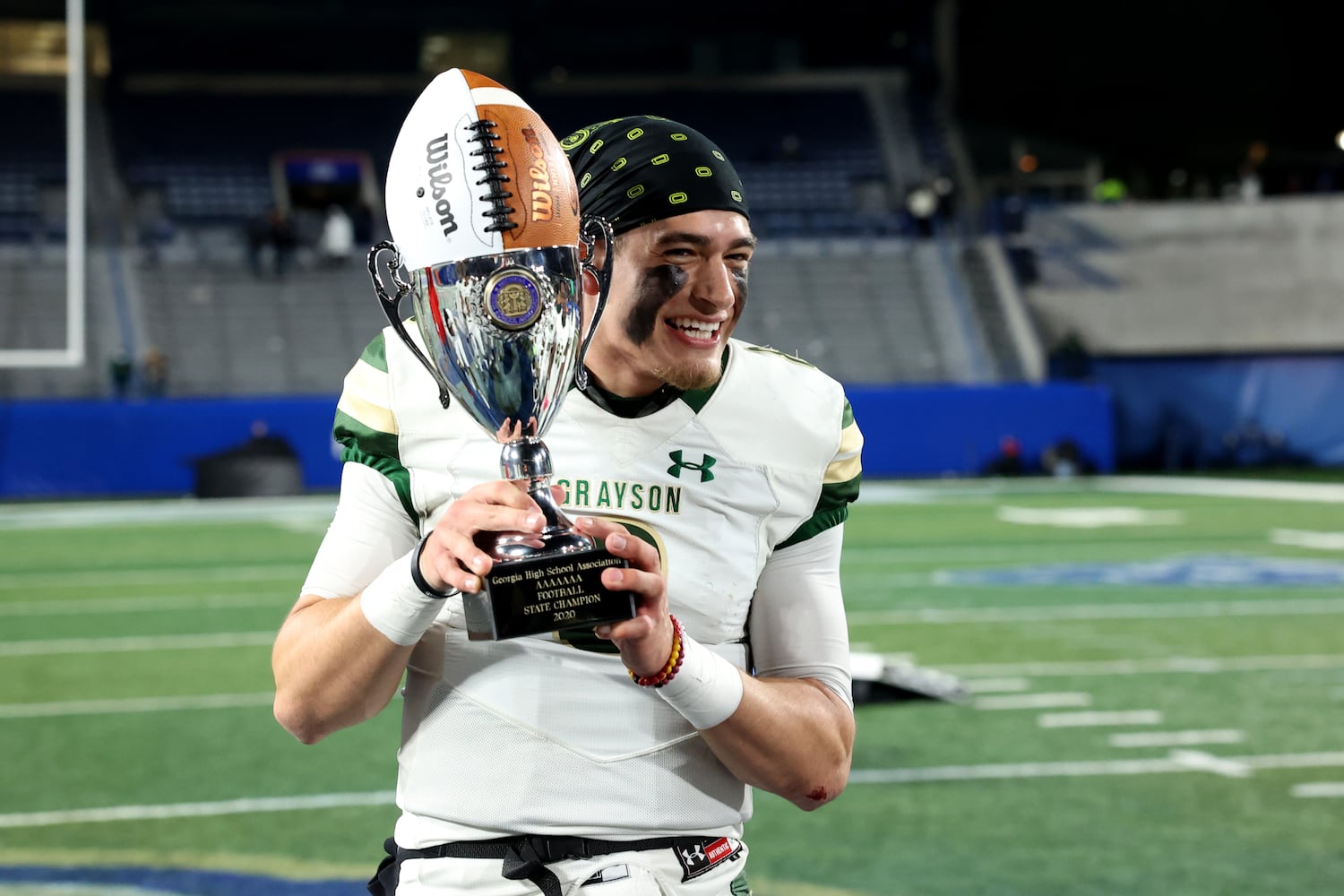 Dec. 30, 2020 - Atlanta, Ga: Grayson quarterback Jake Garcia (8) celebrates with the trophy after their 38-14 win against Collins Hill during the Class 7A state high school football final at Center Parc Stadium Wednesday, December 30, 2020 in Atlanta. JASON GETZ FOR THE ATLANTA JOURNAL-CONSTITUTION