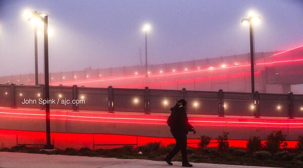 Manu Samuel walks out of the Vine City MARTA station in the fog Monday morning. 