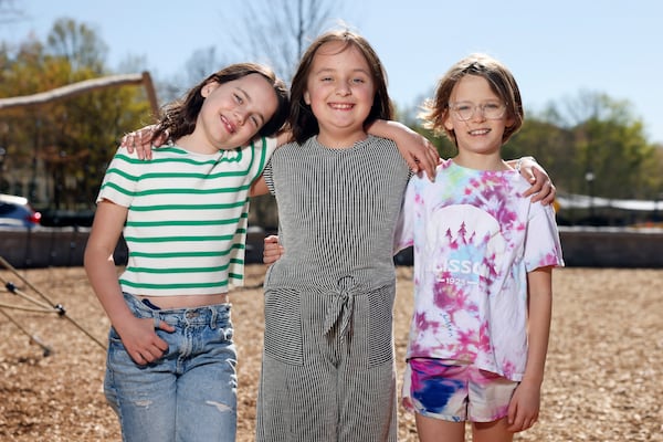 Third graders Berkley Carter (from left), June Simmons and Daphne Murray, from Smyrna Elementary, pose for a photograph at the playground at the Smyrna Community Center, Thursday, March 28, 2024, in Smyrna. These students, also known as the Recess Rangers, went in front of the Cobb County school board to ask for more recess time. (Jason Getz / jason.getz@ajc.com)