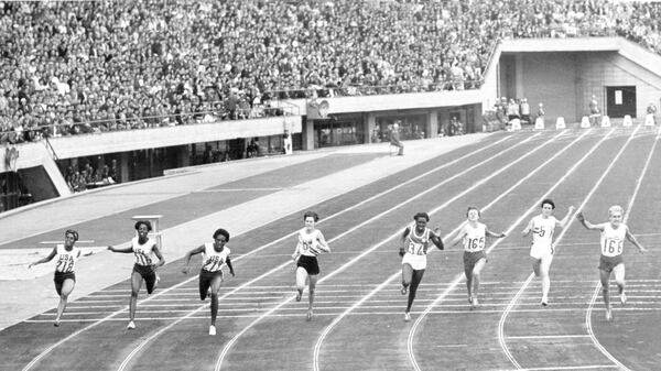 Finalists of the women's 100-meter during dash final of the Summer Olympic event Oct. 16, 1964 in Tokyo. American Wyomia Tyus cuts the ribbon in 11.4 sec. Second was fellow American Edith McGuire (second from left) and third Ewa Klobukowsk, of Poland (top right). Others are Marilyn White, of U.S. (extreme left), Marilyn Black, of Australia (8), and Miguelina Cobian, of Cuba (34). (AP)