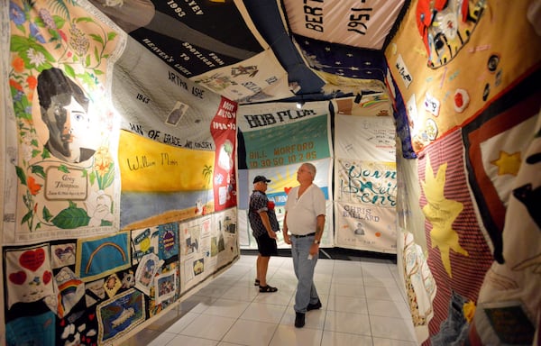 John Pollack and Jim Rosa view panels of the AIDS Memorial Quilt on Dec. 1, World AIDS Day. Compass displayed 28 segments of the quilt, which now includes more than 94,000 names.