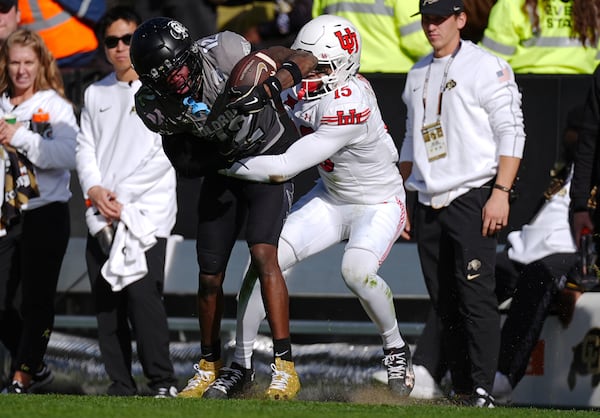 Colorado wide receiver Travis Hunter, left, is tackled by Utah safety Tao Johnson after pulling in a pass in the second half of an NCAA college football game Saturday, Nov. 16, 2024, in Boulder, Colo. (AP Photo/David Zalubowski)