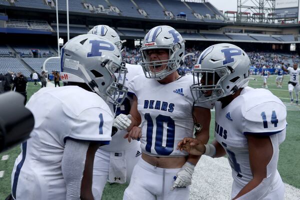 Pierce County running back DJ Bell (1, left) celebrates with Luke Bennett (10) and LJ Newton (14) after Bell scored the game-winning touchdown in overtime. JASON GETZ FOR THE ATLANTA JOURNAL-CONSTITUTION






