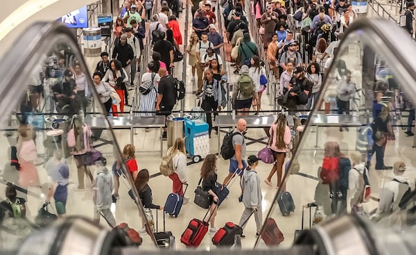 Crowds streamed into Hartsfield-Jackson International Airport on Friday, June 28, 2024, which is expected to be a peak day in the Fourth of July travel period. Credit: John Spink / jspink@ajc.com