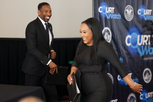 Fulton County District Attorney Fani Willis, right, walks by Atlanta Mayor Andre Dickens before Willis speaks during an event about “Court Watch” at Atlanta City Hall, Tuesday, May 2, 2023, in Atlanta. (Jason Getz / Jason.Getz@ajc.com)