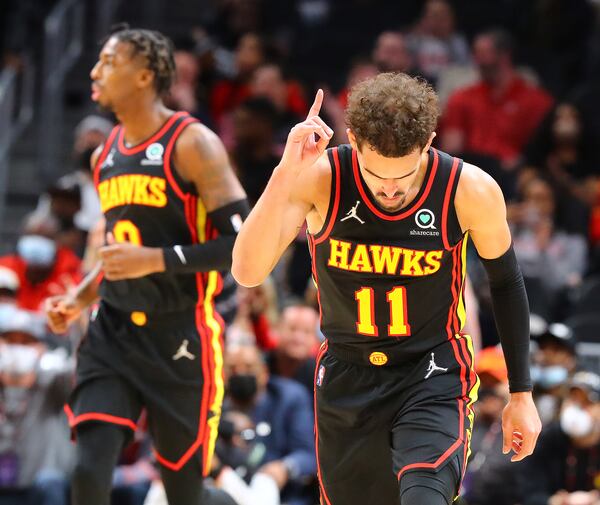 Hawks guard Trae Young reacts to hitting a 3-pointer against the Indiana Pacers during the third period of a 133-112 victory Tuesday night in Atlanta. (Curtis Compton / Curtis.Compton@ajc.com)