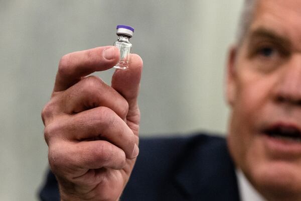 Wesley Wheeler, President of Global Healthcare at United Parcel Service (UPS), holds up a sample of the vial that will be used to transport the Pfizer COVID-19 vaccine as he testifies during a Senate Commerce, Science, and Transportation Subcommittee hearing on the logistics of transporting a COVID-19 vaccine on December 10, 2020 in Washington, DC. (Samuel Corum/Pool/Getty Images)