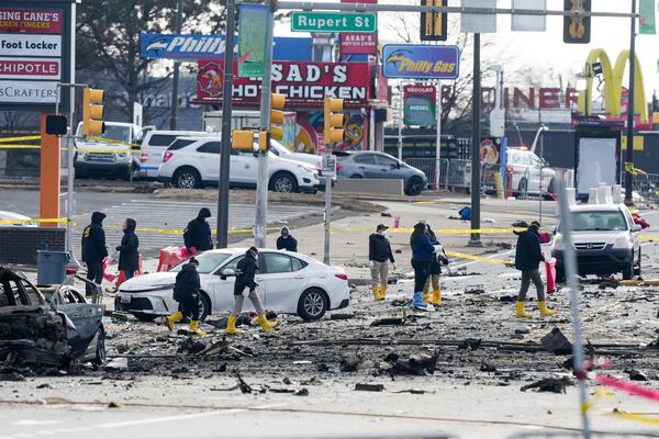 Investigators work the scene after a small plane crashed in Philadelphia, Saturday, Feb. 1, 2025. (AP Photo/Matt Rourke)