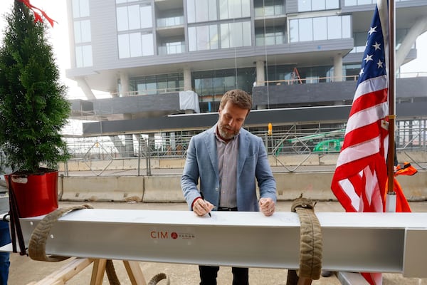 Brian McGowan, President of Centennial Yards, is seen signing the piece of the roof, marking a milestone in the construction of the Phoenix Hotel, which has now reached its highest point. The boutique hotel is one of six buildings currently under construction at Centennial Yards in Downtown Atlanta.
(Miguel Martinez / AJC)