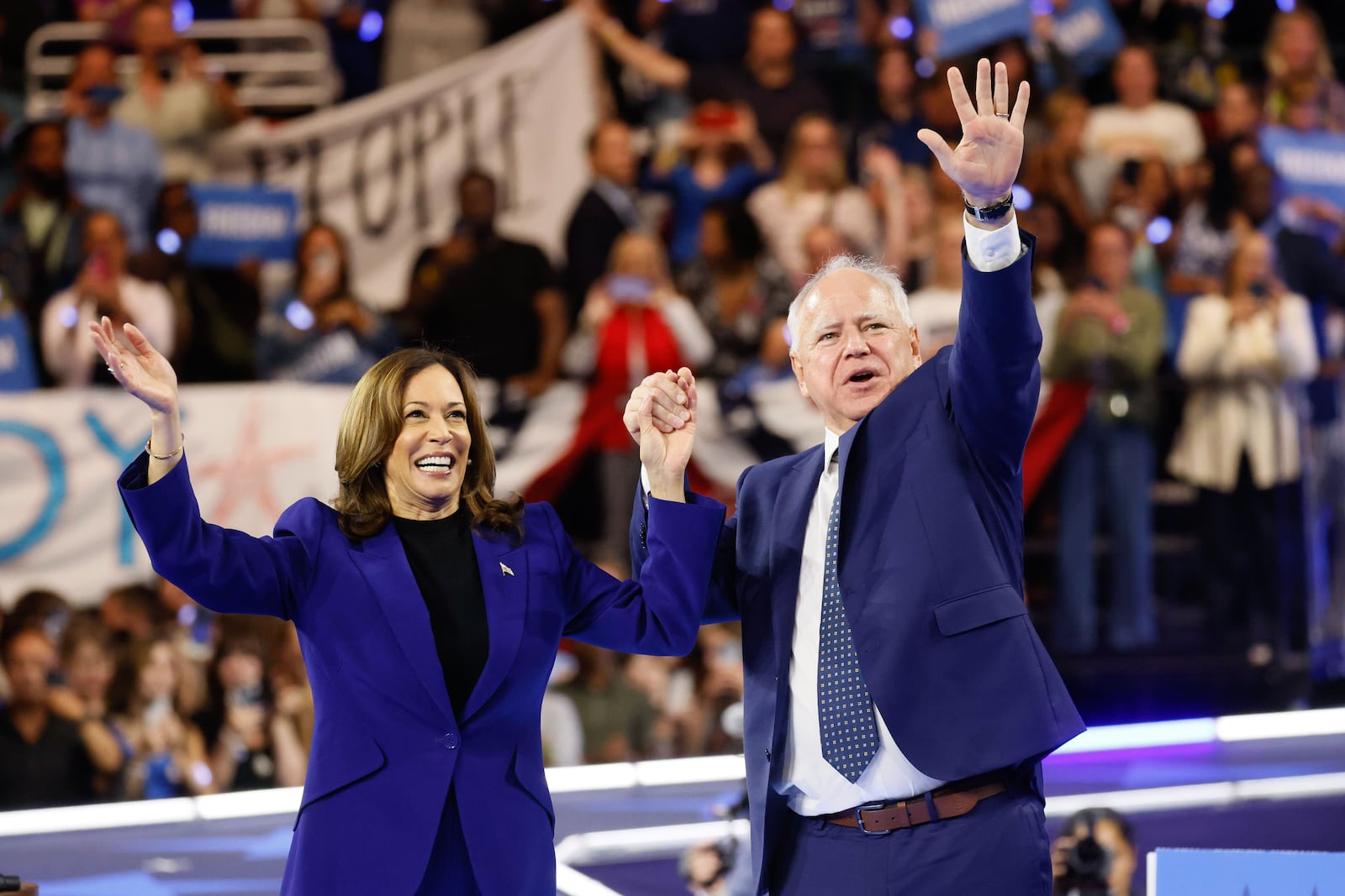 Vice President Kamala Harris and her running mate, Minnesota Gov. Tim Walz, wave to supporters at a rally in Milwaukee on Tuesday.