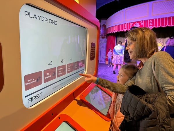 Claire Reid plays a sorting game with her granddaughter Mary Marshall at the Goizueta Children's Experience at the Atlanta History Center. RODNEY HO/rho@ajc.com