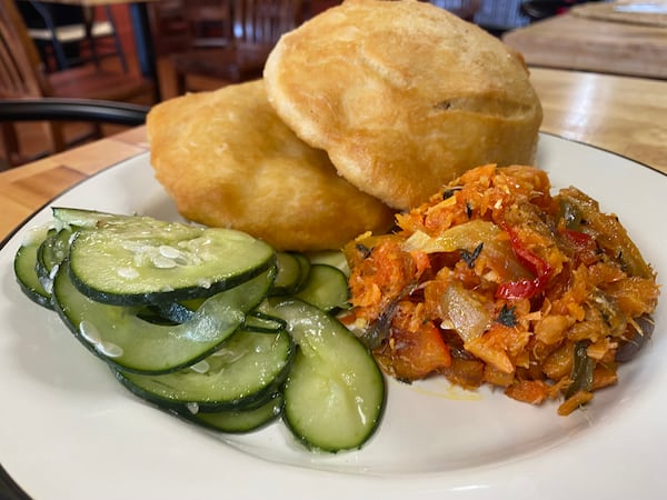 The St. Lucia breakfast features saltfish and bake, with vinegar cucumbers. Ligaya Figueras/ligaya.figueras@ajc.com