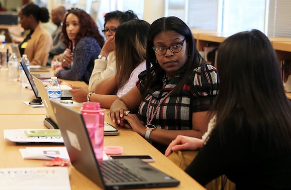 Shaketha Blankenship (left), counselor for Atlanta Public Schools, talks with Tina Pellechia (right), counselor for Atlanta Public Schools, during a training session on how to use a new computer-based college search tool on Monday, Jan. 27, 2020, at Maynard Jackson High School in Atlanta. (Christina Matacotta/crmatacotta@gmail.com)