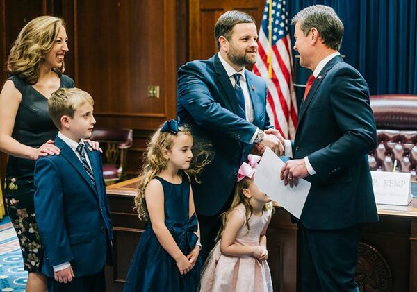 State Rep. Tim Fleming (left, shaking hands with Gov. Brian Kemp) is unhappy that Rivian has received incentives to grow production in Illinois while delaying operations in Georgia. 