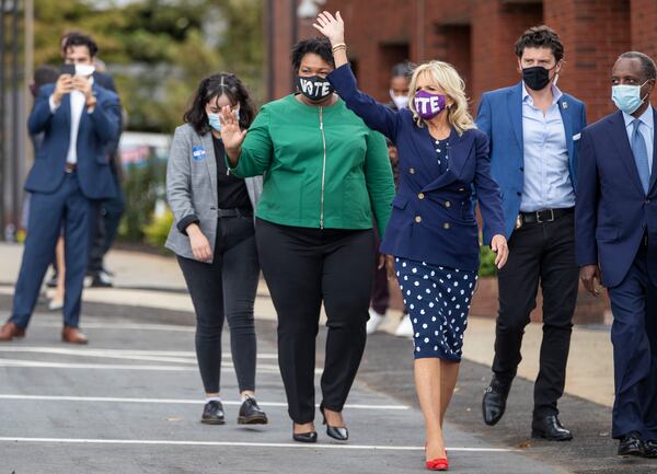 Jill Biden and former gubernatorial candidate Stacey Abrams wave to a crowd gathered at a rally in Decatur for Joe Biden and Kamala Harris in October. (Alyssa Pointer / Alyssa.Pointer@ajc.com)