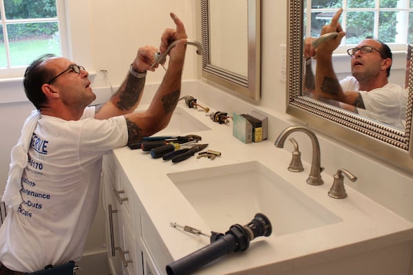 Jeffery Zales, a technician for ProServe Home Solutions, installs a faucet in a house on Sherbrooke Drive in Atlanta that is being renovated Kismet Holdings, Inc., a company run by Steve Mortimer and his brother, Greg. Jenna Eason / Jenna.Eason@coxinc.com