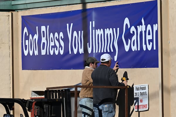 A banner reading “God Bless You Jimmy Carter” is being installed in Plains on Wednesday. Hyosub Shin/AJC