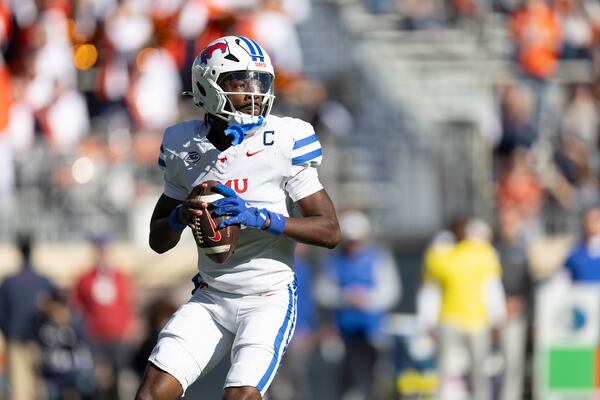 Southern Methodist quarterback Kevin Jennings (7) looks to pass during the first half of an NCAA college football game against Virginia, Saturday, Nov. 23, 2024, in Charlottesville, Va. (AP Photo/Mike Kropf)