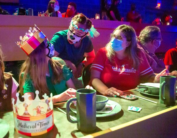 Girl Scouts Troop Leader Bridgette McNeal (right) and her daughter Julia, 11, (left), talk with people while waiting for the Medieval Times show to start at Sugarloaf Mills Mall in Lawrenceville Saturday. McNeal escorted her daughter and other girls there for a troop outing. Julia is looking forward to summer camp. May 22, 2021.   STEVE SCHAEFER FOR THE ATLANTA JOURNAL-CONSTITUTION