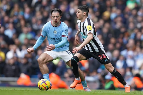 Newcastle's Miguel Almiron, right, challenges for the ball with Manchester City's Jack Grealish during the English Premier League soccer match between Manchester City and and Newcastle, at the Etihad stadium in Manchester, England, Saturday, March 4, 2023. (AP Photo/Dave Thompson)