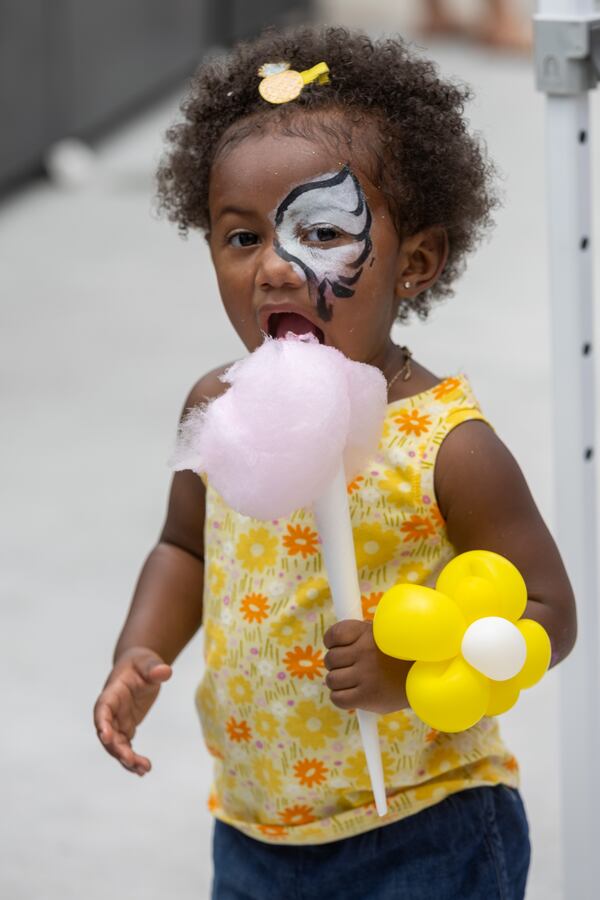  Summer Lockhart, 2, enjoys her cotton candy at the SkyView Atlanta Observation Wheel 10th anniversary celebration in downtown Atlanta Saturday, July 15, 2023.  (Steve Schaefer/steve.schaefer@ajc.com)