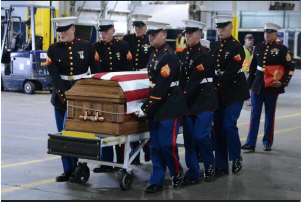 Wells' coffin was welcomed by Delta's Honor Guard and escorted from the plane by a US Marine guard after landing in Atlanta. Photo: Delta News Hub. Used with permission.