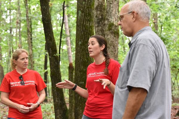 From left, Joell Brule, Laura Walsh and Robert Protasewich — members of “Rural Gwinnett,” which is fighting new development in what’s left of the rural eastern side of Gwinnett — discuss the proposed rezoning area in Dacula on Tuesday, June 12, 2018. HYOSUB SHIN / HSHIN@AJC.COM