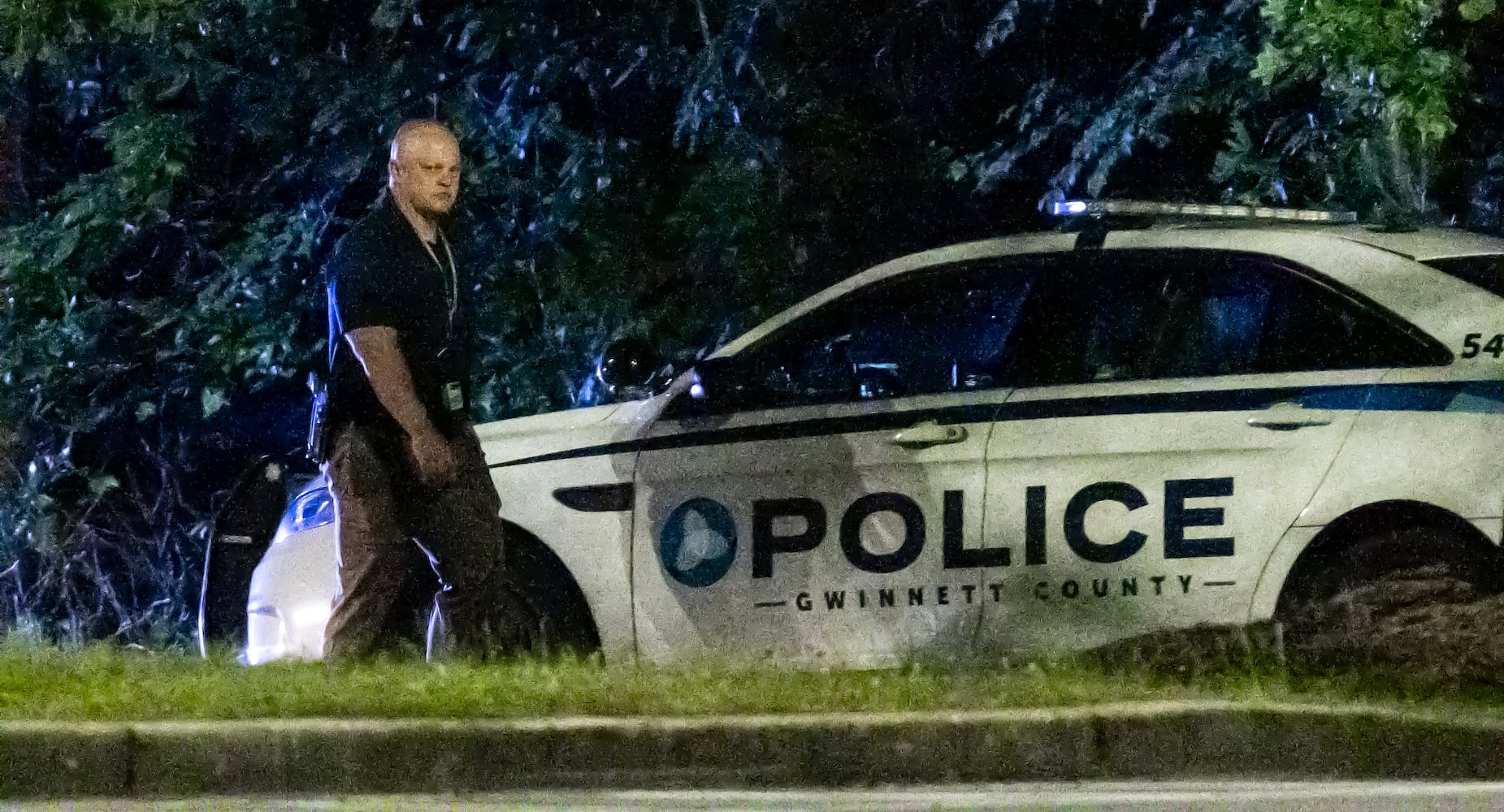 Gwinnett police examine the scene of a shooting, where a man and three children shot to death inside a car at Lucky Shoals Park outside of Tucker on Wednesday, May 8, 2024. The man was in the driver’s seat. He, a boy and two girls all appeared to have been shot. Their names and ages were not released, but authorities said the children appeared to have been in elementary and middle school.  (John Spink/AJC)