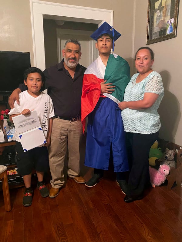 Ever Lopez celebrates his graduation from high school with his family in Asheboro, North Carolina, on Thursday. The school district says Lopez did not receive his diploma because he violated the school’s dress code, and because he had “detracted from the importance and the solemnity of the ceremony” by wearing a Mexican flag over his shoulders at the graduation ceremony. 