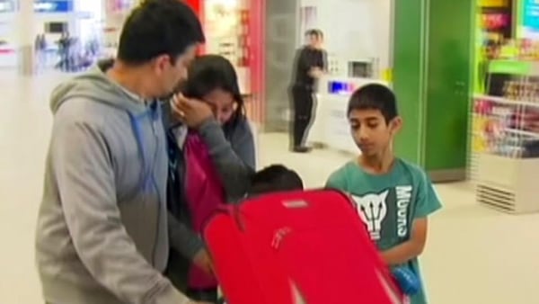 This Sunday, Oct. 15, 2017 image made from video shows a crying passenger at an airport in Perth, Australia after an Indonesia AirAsia flight from Australia to the holiday island of Bali returned safely to the airport. Passengers on the flight described a panicked flight crew announcing an emergency and oxygen masks dropping from the ceiling after their airliner lost cabin air pressure and rapidly descended. (Channel 7 via AP)