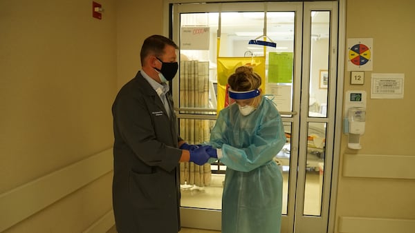 Phoebe Putney Chaplain, the Rev. Will Runyon, praying with Anna Grace Fulmer, a nurse in one of Phoebe Putney's COVID ICUs (Photo Courtesy of Phoebe Putney)