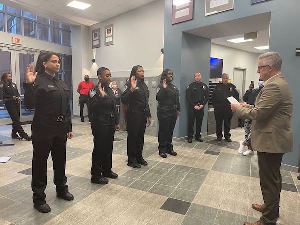 John Robison, Alpharetta's director of public safety, swears in four 911 Communications Officers following their successful completion of training in 2021. (Courtesy of the city of Alpharetta)