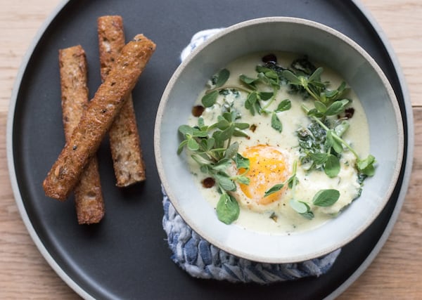 The coddled farm egg at Bacchanalia, with spinach, parmesan and maple. CONTRIBUTED BY HENRI HOLLIS