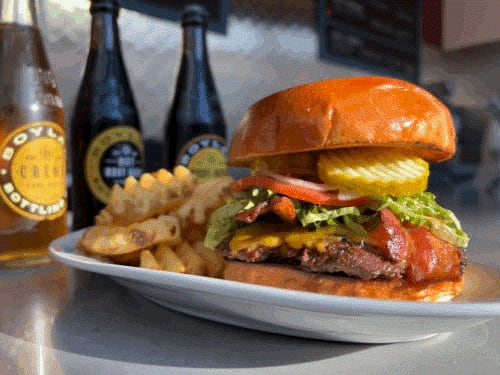 A cheddar burger with bacon is on the menu at Smoq'n Hot Grill, which is closing its location in the Collective Food Hall at Coda. / Courtesy of Smoq'n Hot Grill