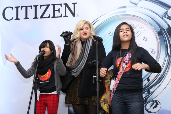 NEW YORK, NY - NOVEMBER 19: Kelly Clarkson performs with young fans at Citizen Watch Company Global Flagship Store Opening at Citizen Watch Company Global Flagship Store on November 19, 2014 in New York City. (Photo by Rob Kim/Getty Images) NEW YORK, NY - NOVEMBER 19: Kelly Clarkson performs with young fans at Citizen Watch Company Global Flagship Store Opening at Citizen Watch Company Global Flagship Store on November 19, 2014 in New York City. (Photo by Rob Kim/Getty Images)