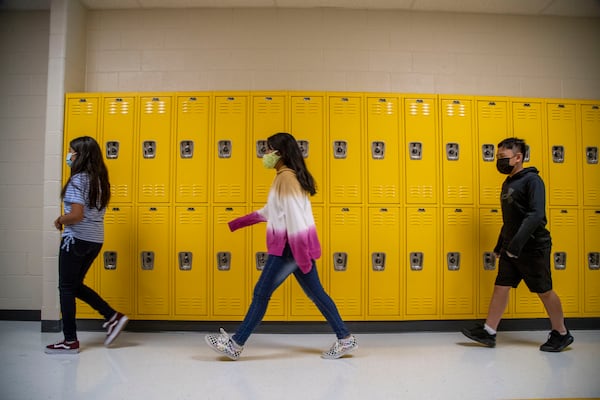 Masks are option in the Cobb County School District, but these students opted to wear them during the first day of school at Pearson Middle School in Marietta on Aug. 2, 2021. The district reported 185 cases of COVID-19 during the first week, but none at Pearson Middle School.(Alyssa Pointer/Atlanta Journal Constitution)