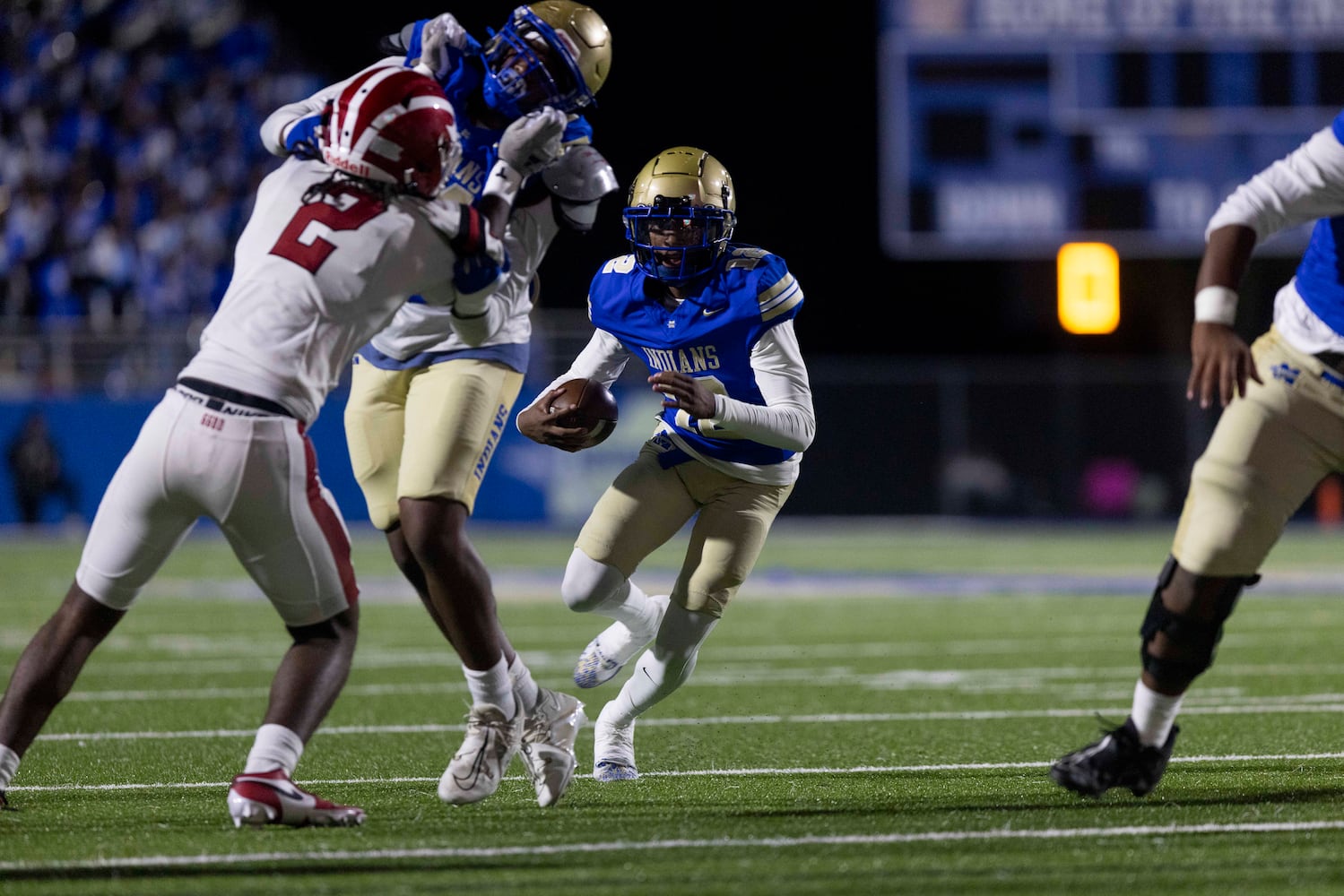 McEachern quarterback Calvin Pittman (12) runs the ball during a NCAA High School football game between Hillgrove and McEachern at McEachern High School in Powder Springs, GA., on Friday, October 18, 2024. (Photo/Jenn Finch, AJC)