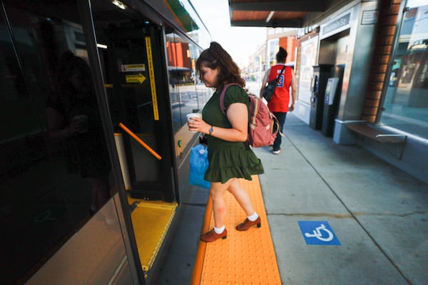 A student at the University of Indianapolis, Abigail Wittenmyer, gets on the city's Red Line bus rapid transit. "I don't own a car, so for me the Red Line is a good option for me to go to work" Wittenmyer said. Miguel Martinez / miguel.martinezjimenez@ajc.com 