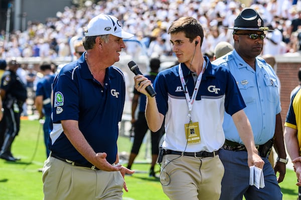 Wiley Ballard (right) speaks to former Georgia Tech coach Paul Johnson at halftime of a game. (Danny Karnik/GT Athletics)