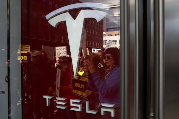 Demonstrators take part in a protest against Elon Musk and Tesla outside of a Tesla showroom, Saturday, March 01, 2025 in New York. (AP Photo/Adam Gray)