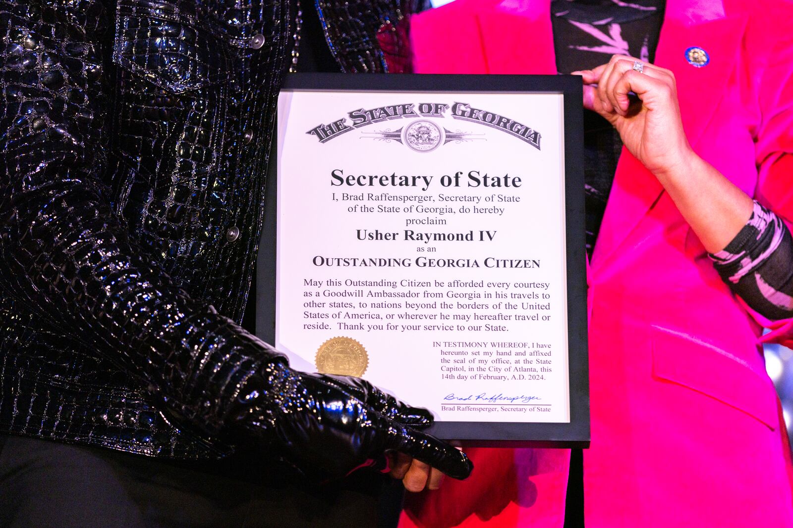 Usher receives an honor from members of the Georgia State Legislature during a homecoming rally at Clark Atlanta University in Atlanta on Wednesday, February 14, 2024. (Arvin Temkar / arvin.temkar@ajc.com)