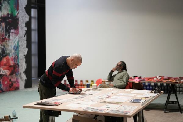 French street artist Shuck One works on a mural for the exhibition "Paris Noir", at the Centre Pompidou Museum, in Paris, Tuesday, Feb. 18, 2025. (AP Photo/Thibault Camus)