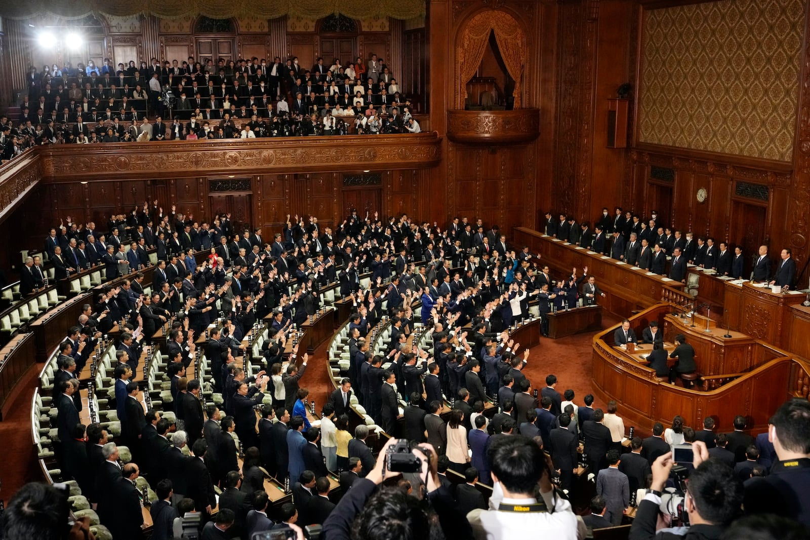 Lawmakers give three cheers after dissolving the lower house, the more powerful of the two parliamentary chambers, during an extraordinary Diet session at the lower house of parliament Wednesday, Oct. 9, 2024, in Tokyo. (AP Photo/Hiro Komae)