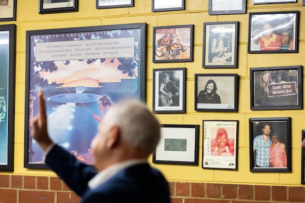 Minnesota Gov. Tim Walz, the running mate of Vice President Kamala Harris, speaks to supporters at H&H Soul Food Restaurant in Macon on Tuesday, Sept. 17, 2024. Pictures of musicians, including the Allman Brothers Band, appear in the background. (Arvin Temkar/AJC)